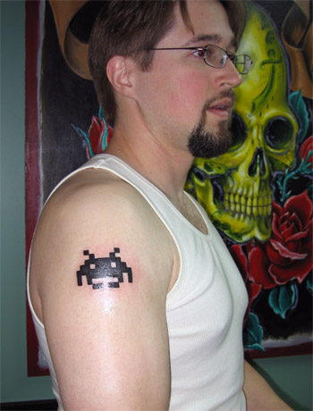 tattoos on shoulder. geek tattoo), a Space Invader,